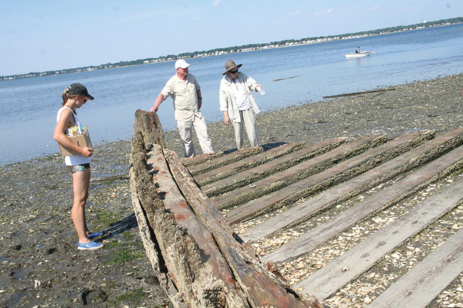 LESS THAN THERE WAS LAST YEAR: Rep. Joseph McNamara and Dr. Kathy Abbass confer near the bow of the wreck that is starting to break up with exposure from its sandy grave.